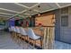 Stylish bar area featuring granite countertops, seating, and custom cabinetry at 11103 Bridge House Rd, Windermere, FL 34786