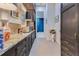 Long bar with sink, dark wood cabinets, and view to hallway with blue curtains at 11103 Bridge House Rd, Windermere, FL 34786
