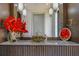 Modern bathroom vanity with marble countertop, stylish light fixtures, and decorative red orchids at 11103 Bridge House Rd, Windermere, FL 34786
