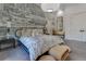 Stylish bedroom featuring a decorative accent wall, neutral tones, and modern furnishings at 11103 Bridge House Rd, Windermere, FL 34786
