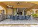 Inviting covered patio featuring a full outdoor kitchen and ample dining space for entertaining at 11103 Bridge House Rd, Windermere, FL 34786