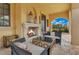 Cozy outdoor fireplace, with comfortable seating and tranquil garden views, perfect for relaxation at 11103 Bridge House Rd, Windermere, FL 34786