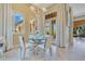 Bright dining room with a glass table, white chairs, and large windows that provide a lovely view at 11103 Bridge House Rd, Windermere, FL 34786