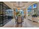 A formal dining area with a wine cellar, designer lighting, and lake views at 11103 Bridge House Rd, Windermere, FL 34786