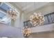 Elegant foyer with decorative chandeliers, iron railings, and soaring ceilings at 11103 Bridge House Rd, Windermere, FL 34786