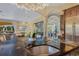 Modern kitchen island with sink and soapstone counters opens to living areas and outdoor views at 11103 Bridge House Rd, Windermere, FL 34786
