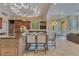 Open kitchen with island, granite countertops, wine storage, and stainless appliances at 11103 Bridge House Rd, Windermere, FL 34786