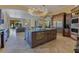 Gourmet kitchen with island sink, adjacent living room and wine storage at 11103 Bridge House Rd, Windermere, FL 34786