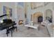 A spacious living room with fireplace, piano, and elegant decor, perfect for entertaining and relaxation at 11103 Bridge House Rd, Windermere, FL 34786