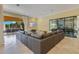 Spacious living room with a large sectional, travertine floors, and seamless access to outdoor patio area at 11103 Bridge House Rd, Windermere, FL 34786