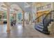 Open concept living area with soaring ceilings, columns, staircase, lake views, and ample space for entertaining at 11103 Bridge House Rd, Windermere, FL 34786
