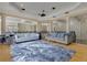 Upstairs loft area featuring columns, hardwood floors, and stylish furnishings at 11103 Bridge House Rd, Windermere, FL 34786
