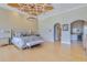 Spacious main bedroom featuring a decorative ceiling, chandelier, and seamless access to the attached bathroom at 11103 Bridge House Rd, Windermere, FL 34786
