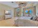 Bright main bedroom with a large window, chandelier, light-colored wood floors, and outdoor access at 11103 Bridge House Rd, Windermere, FL 34786