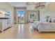 Bright and open main bedroom featuring hardwood floors, a seating area, and access to outdoor space at 11103 Bridge House Rd, Windermere, FL 34786