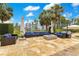 Spacious outdoor patio with stylish blue lounge furniture, ideal for relaxation and entertainment by the water at 11103 Bridge House Rd, Windermere, FL 34786