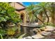 Secluded patio and pond with outdoor dining and a relaxing water feature at 11103 Bridge House Rd, Windermere, FL 34786