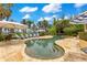 Inviting pool area with lounge chairs, umbrellas, and a serene water view at 11103 Bridge House Rd, Windermere, FL 34786