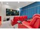 Home theater with comfortable red leather recliners, movie screen, and luxurious seating for immersive entertainment at 11103 Bridge House Rd, Windermere, FL 34786