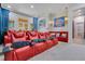 Inviting theater room with plush red reclining chairs, providing an immersive cinematic experience at home at 11103 Bridge House Rd, Windermere, FL 34786