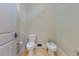 Clean half bathroom featuring a bidet and toilet with neutral-colored walls and flooring at 11103 Bridge House Rd, Windermere, FL 34786