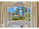 Bedroom view of landscaped backyard with patio seating, lounge chairs, and lake access at 11103 Bridge House Rd, Windermere, FL 34786