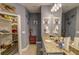 Bathroom featuring a granite countertop, and organized closet space at 114 Vista Verdi Cir # 116, Lake Mary, FL 32746