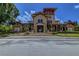 Beautiful clubhouse with a grand entrance, stone staircase, and well-manicured landscaping on a sunny day at 114 Vista Verdi Cir # 116, Lake Mary, FL 32746
