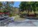Apartment building with landscaping, mature trees, and parking at 114 Vista Verdi Cir # 116, Lake Mary, FL 32746