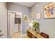 Bright hallway featuring a bench, decor and a door to a laundry room at 114 Vista Verdi Cir # 116, Lake Mary, FL 32746