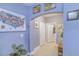 Inviting hallway with tiled flooring and art pieces leading to the laundry room at 114 Vista Verdi Cir # 116, Lake Mary, FL 32746