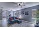 Comfortable living room featuring a modern ceiling fan and a cozy blue couch at 114 Vista Verdi Cir # 116, Lake Mary, FL 32746