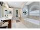 Bathroom with soaking tub and glass enclosed shower at 1154 Kerwood Cir, Oviedo, FL 32765