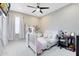 Bedroom with white bed, pink accents, and desk area at 1154 Kerwood Cir, Oviedo, FL 32765