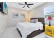 Bedroom with fan, large windows, and bright yellow end table at 1154 Kerwood Cir, Oviedo, FL 32765