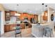 Modern kitchen featuring stainless steel appliances, granite countertops, and wooden cabinetry at 1154 Kerwood Cir, Oviedo, FL 32765