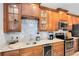 Well-lit kitchen with granite countertops, stainless steel appliances, and wine rack at 1154 Kerwood Cir, Oviedo, FL 32765