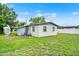 View of the home's rear exterior, showing a fenced backyard with a shed and plenty of green space at 1170 E Bay St, Winter Garden, FL 34787