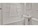 Clean white bathroom featuring a shower-tub combo and pedestal sink at 1170 E Bay St, Winter Garden, FL 34787
