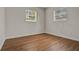 Bedroom with two bright windows, wood-look floors and neutral walls at 1170 E Bay St, Winter Garden, FL 34787