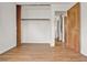 Empty bedroom featuring wood-look floors, with a closet and view into hallway at 1170 E Bay St, Winter Garden, FL 34787