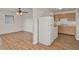 View of the kitchen and dining area featuring wood floors, white appliances, and wooden cabinets at 1170 E Bay St, Winter Garden, FL 34787