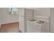 Kitchen featuring white appliances and wood-look floors at 1170 E Bay St, Winter Garden, FL 34787