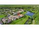 Aerial view of home with lush landscaping backing onto a serene pond and green space at 118 Ventana Dr, Kissimmee, FL 34759