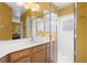 Bathroom with shower and vanity with wood cabinets and white countertop at 118 Ventana Dr, Kissimmee, FL 34759