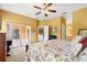 Spacious bedroom with a ceiling fan, access to the patio, and sliding glass doors at 118 Ventana Dr, Kissimmee, FL 34759