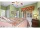 Comfortable bedroom with a ceiling fan, a large bed, and access to the backyard at 118 Ventana Dr, Kissimmee, FL 34759