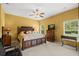 Bright bedroom with a ceiling fan, a king-size bed, and a wooden dresser at 118 Ventana Dr, Kissimmee, FL 34759