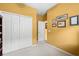 Hallway with closet doors and art on the wall at 118 Ventana Dr, Kissimmee, FL 34759