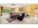 Bright living room with tile floors, slider doors to lanai, and comfortable seating area at 118 Ventana Dr, Kissimmee, FL 34759